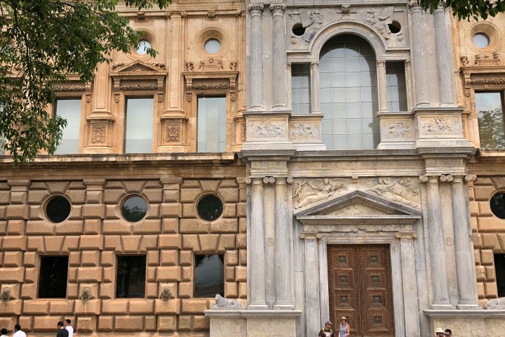 a group of people walking in front of a building
