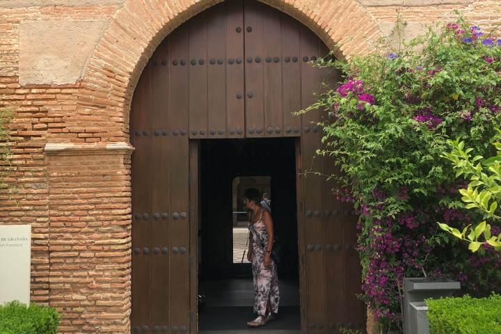 a garden in front of a brick building